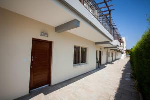 a row of houses with a door and a walkway at Crystallo Apartments in Paphos