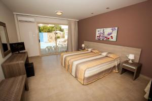 a bedroom with a large bed and a window at Crystallo Apartments in Paphos