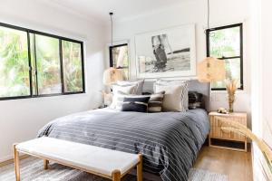 a bedroom with a bed and two windows at BERRIMA LUXE - Noosa Hill Home - Heated Pool in Noosa Heads +22 photos