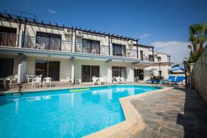 a large swimming pool in front of a building at Crystallo Apartments in Paphos