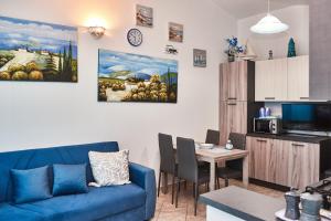 a living room with a blue couch and a table at Villetta Vista Mare in Cala Gonone