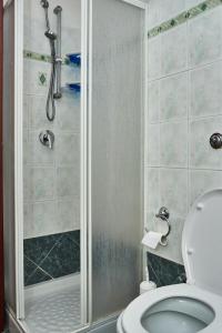 a bathroom with a shower and a toilet at Villetta Vista Mare in Cala Gonone +32 photos