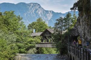 a bridge over a river with a mountain in the background at Haus Evelin in Kundl