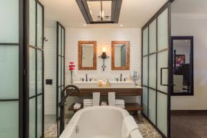 a bathroom with a tub and a sink at Hacienda Encantada Resort & Spa in Cabo San Lucas