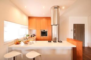 a kitchen with a large white counter top and wooden cabinets at Summer Breeze apartment in Zadar