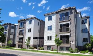 an image of three apartment buildings on a street at Capri 209 in the Heart of Downtown Traverse City in Traverse City
