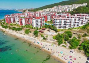 an aerial view of a beach with buildings and the ocean at 2-комнатные апартаменты у моря 10 бассейнов Crown Fort Noks in Sveti Vlas