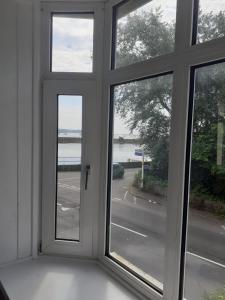 an empty room with a window with a view of a street at The Croft Guest House - Cockwood Harbour Near Exeter in Exeter