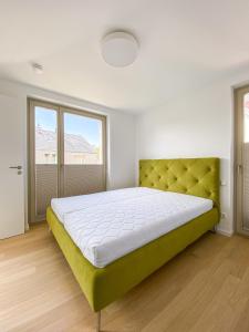 a bedroom with a large bed with a green headboard at Strandläufer 2 in Zingst