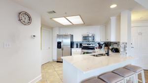 a white kitchen with a sink and a refrigerator at 5506 Hampton Place South in Hilton Head Island