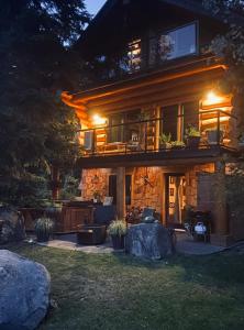 a house with a patio and a porch at night at A Suite Retreat - Beyond Bed & Breakfast in Sun Peaks