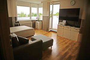 a living room with a couch and a flat screen tv at Apartment for a short rent in KaunasButas trumpalaikei nuomai Kaune in Kaunas +27 photos