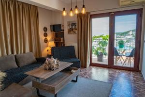 a living room with a couch and a table at MarGio Skiathos Apartments in Skiathos