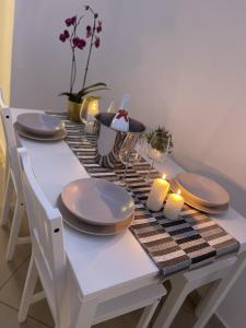 a table with plates and candles on a table at HOME SWEET HOME Storia di Napoli in Naples