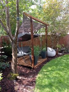 a gazebo with a hammock in a garden at Movie nights and Chill in Manchester