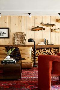 a living room with a couch and a table at Bluebird Sunapee in Mount Sunapee