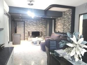 a living room with a couch and a table at EnjoyRhodes Villa near Faliraki in Kalithies +23 photos