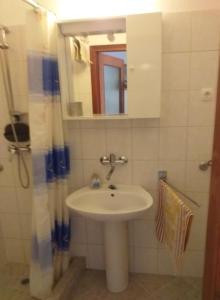 Apartments Jakov في ستاريغراد: حمام مع حوض ومرآة