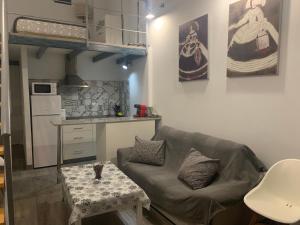 a living room with a couch and a table at HOLIDAY ALYMA in Sanlúcar de Barrameda