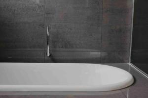 a white toilet in a bathroom with a faucet at Martyrs Lookout - Luxury Accommodation in Peterborough +69 photos