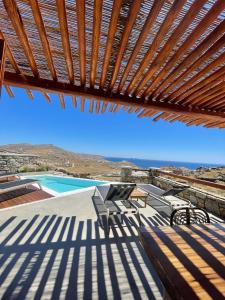 a view from the deck of a villa with a swimming pool at Teal Rock Mykonos in Ano Mera