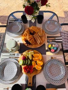 a table topped with plates of food and fruit at Villa Doreta in Roda