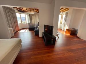 1 dormitorio con sala de estar con TV y sofá en Villa Neila, Fuerteventura en Tarajalejo