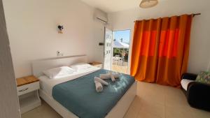 a bedroom with a bed with two towels on it at Rida Village Ksamil Island in Ksamil