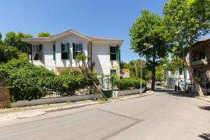 a white house on the side of a street at No16 Ada in Adalar