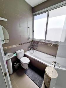 a bathroom with a toilet and a tub and a sink at Leonidas VILLA in Paphos