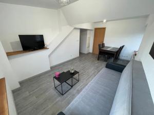 A television and/or entertainment centre at Belfort Appartement confort