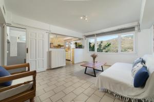 a bedroom with a bed and a table in a room at Victoria's Summerhouse in Andros