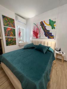 una camera da letto con un letto e due dipinti alle pareti di Sunny breeze apartment a Vlorë