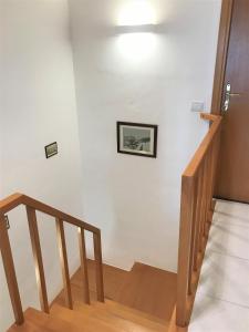 a stairway with a picture on a white wall at Vecchia Paradiso - A un passo dal Mare in Messina