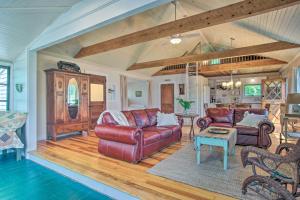 a living room with two leather couches and a table at Peaceful Long Pond Cottage with Dock and Views in Rochester