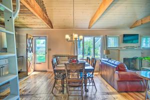 a dining room and living room with a table and chairs at Peaceful Long Pond Cottage with Dock and Views in Rochester