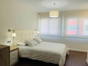 A bed or beds in a room at A Misericordia Viveiro