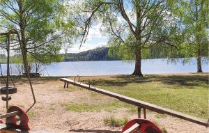 a park bench next to a body of water at 3 Bedroom Beautiful Home In Bullebo in Bullebo
