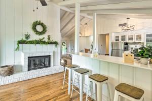 a kitchen and living room with a fireplace at Stylish Franklin Cabin on 6 Private Acres! in Franklin