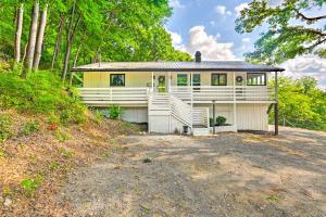 a white house with a porch and a driveway at Stylish Franklin Cabin on 6 Private Acres! in Franklin