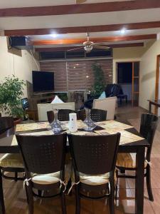 a dining room with a table and chairs at CASA VILLA AZUL 3 PISOS in Antofagasta