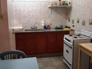 a kitchen with a stove and a sink at La Viñita in Cafayate