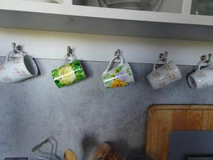 a group of bags hanging on a kitchen wall at GRUNWALD APARTMENTS in Szczecin