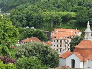 a view of a town with buildings and a church at PIMENTA FOUR HOUSE in Amarante