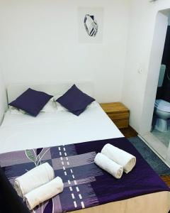 a bedroom with a bed with towels on it at Apartamento Bairro Alto in Lisbon