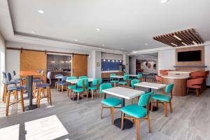 a dining room with tables and chairs and a tv at Best Western Plus Amarillo East Hotel in Amarillo