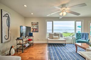 a living room with a ceiling fan and a tv at Cambridge Beach Home on Choptank River with Pier! in Cambridge