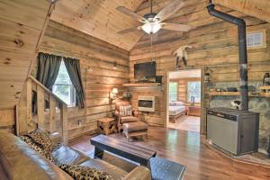 a living room with wooden walls and a ceiling fan at Constantia Cabin Escape More Than 2 Mi to Lake Oneida in Constantia