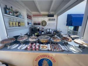 a counter with some food on top of it at Salento Sottovento Luxury BeB in Torre Lapillo