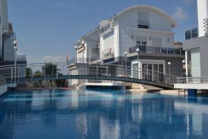 a bridge over a river in front of a building at Antalya belek Mermaid villas 3 bedrooms close the beach park 2 in Belek